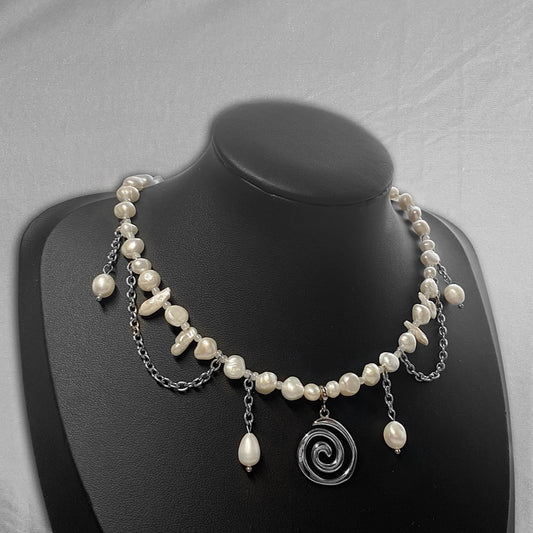 uneven pearl necklace with a stainless steel spiral charm in the middle and hanging chains (14/6)